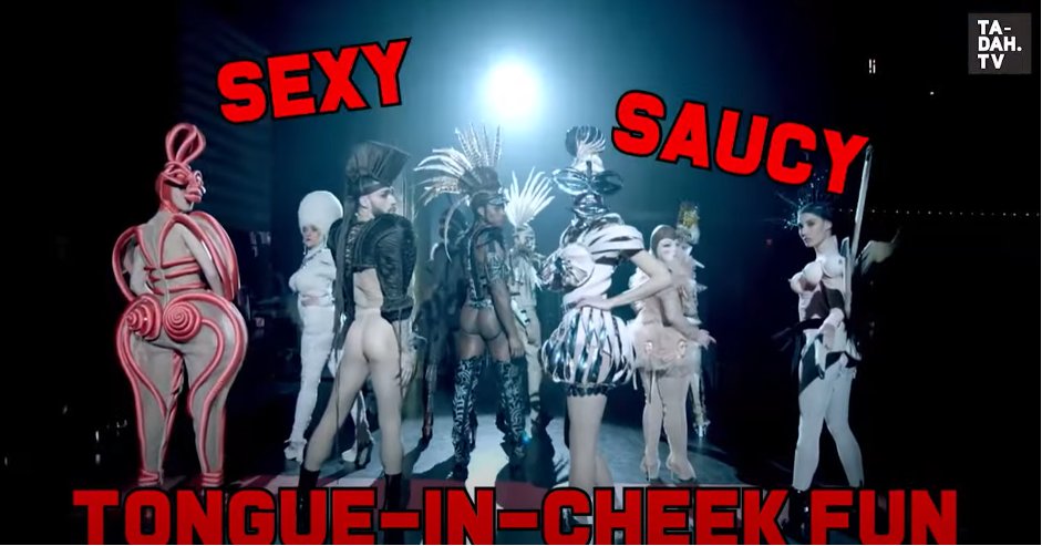 Models in the Fashion Freak Show performance wearing Jean Paul Gaultier’s designs. The words “sexy”, “saucy”, “tongue-in-cheek fun” are written on the screen in bold red and black font.